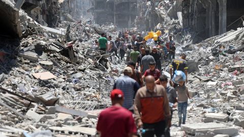 Palestinians carry salvaged belongings as they leave the Jabalya refugee camp in the northern Gaza Strip, after they returned briefly to check on their homes on May 31, 2024.