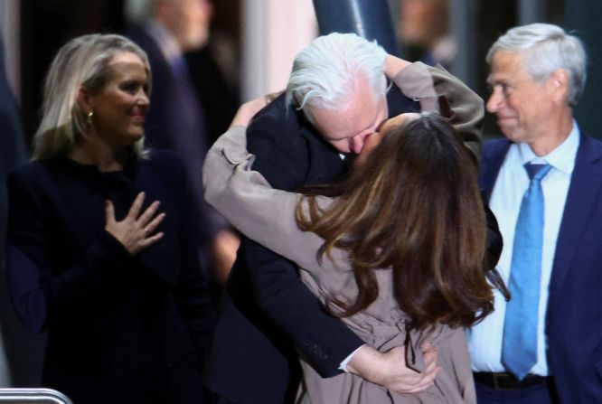 Assange kisses his wife Stella Assange as he arrives in Canberra on June 26.