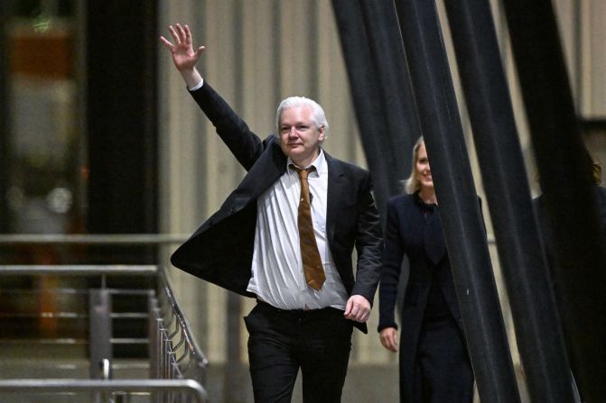 WikiLeaks founder Julian Assange waves after arriving at Canberra Airport in Canberra, Australia, on June 26.