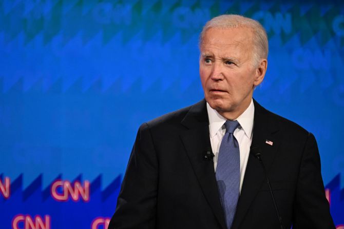 Biden watches Trump during the debate's first hour.