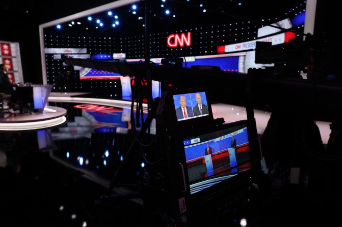 The candidates are seen on monitors from the side of the stage.