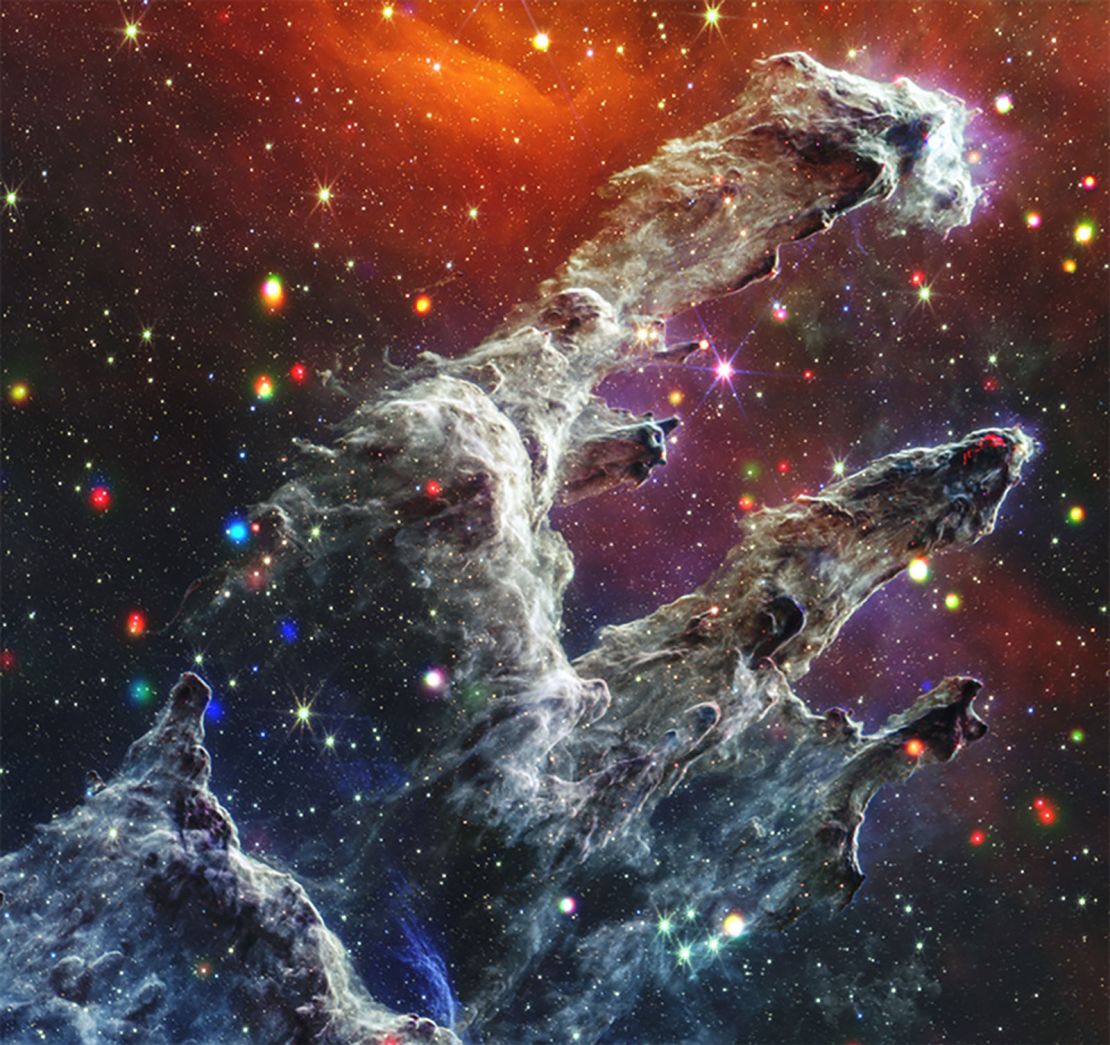 The Pillars of Creation represents a region of star formation where tall columns of dark dust create a stellar nursery. The colorful dots through the image represent young stars  that glow in X-ray and infrared light.