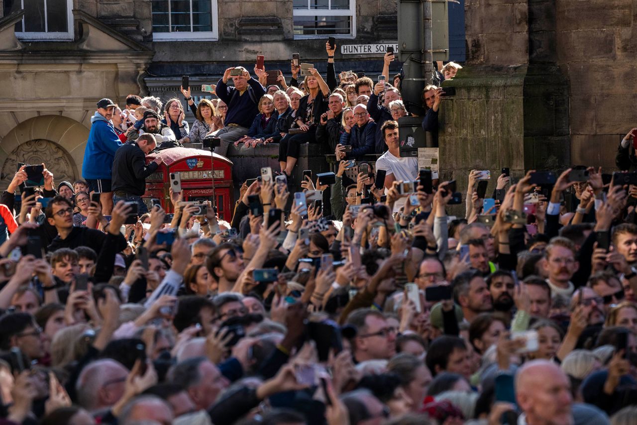 People attend the procession of Queen Elizabeth II's coffin from the Palace of Holyroodhouse to St. Giles' Cathedral on Monday.