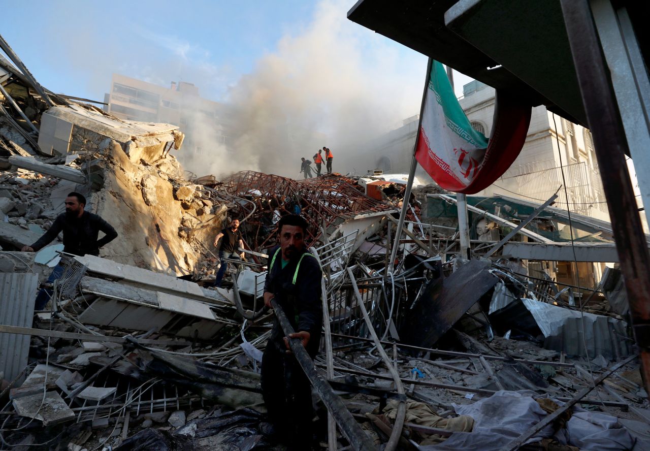 Emergency services work at a building hit by an airstrike in Damascus, Syria, on April 1. 