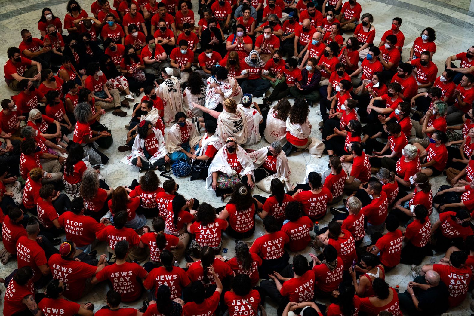 Jewish Voice For Peace protesters sit in the rotunda of the Cannon House Office Building in Washington, DC, on Tuesday, July 23. They were protesting the visit of Israeli Prime Minister Benjamin Netanyahu.