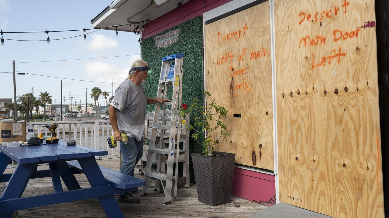 A worker boards up windows at an ice cream parlor ahead of Beryl's landfall in Port Aransas, Texas, on July 6.