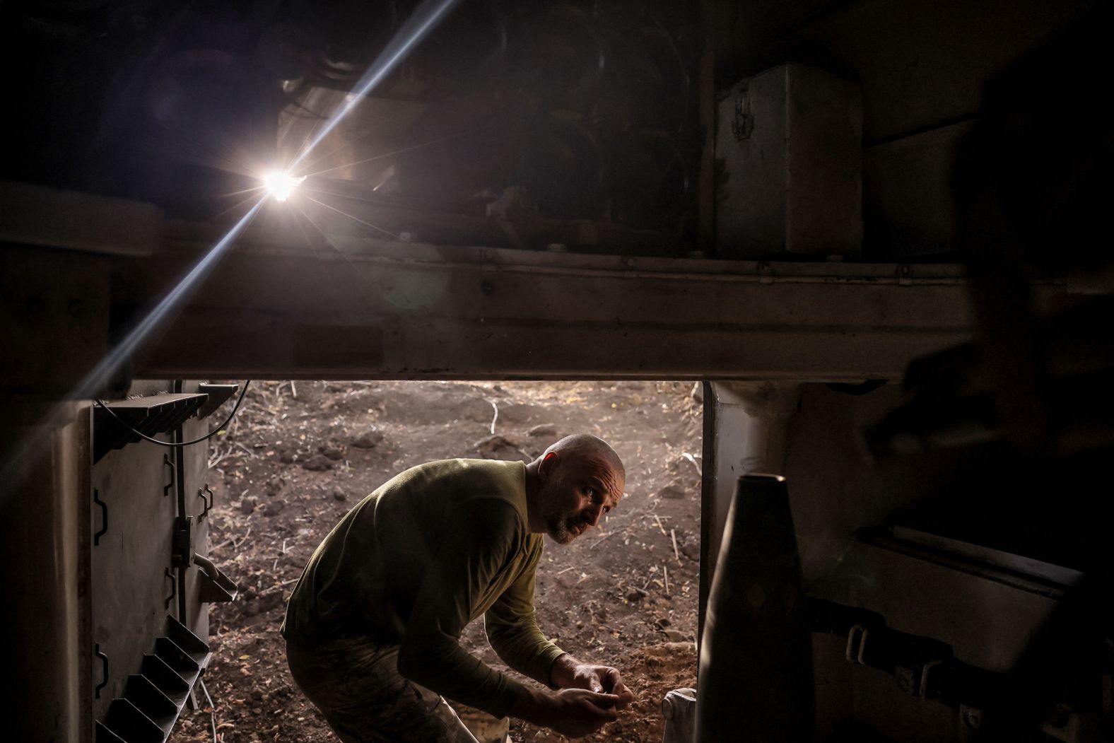 A Ukrainian serviceman prepares a shell for a self-propelled howitzer near the front-line town of Chasiv Yar, Ukraine, on Saturday, July 20.