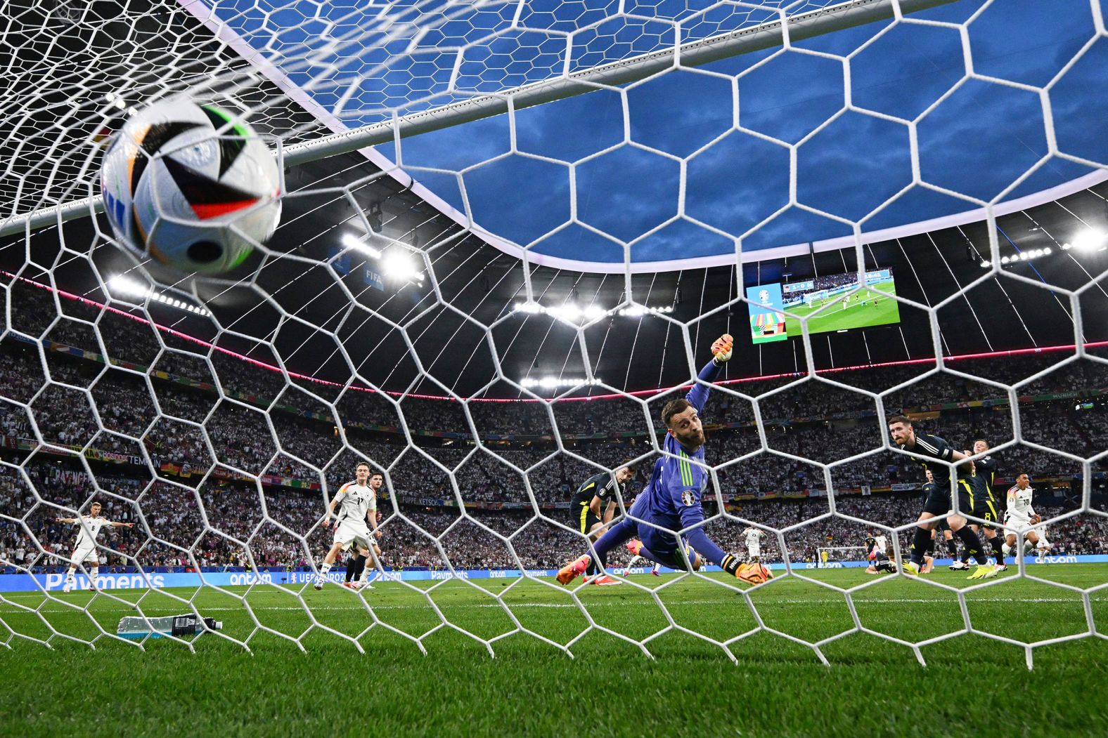 Germany's Jamal Musiala, in white on the right, scores a goal against Scotland during the opening match of Euro 2024 on Friday, June 14. Germany, the host nation, <a href="https://www.cnn.com/2024/06/14/sport/germany-scotland-euro-2024-spt-intl/index.html">won 5-1</a>.