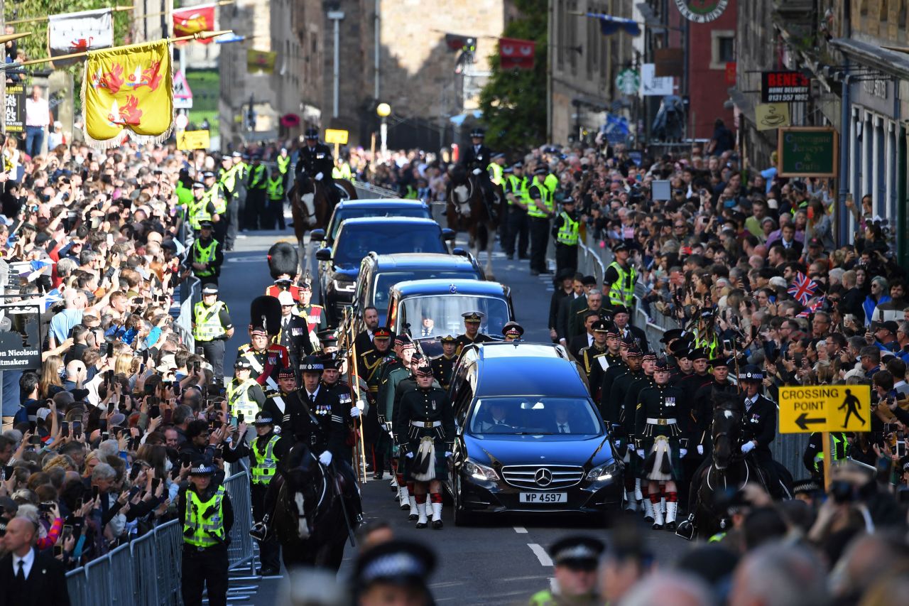 Members of the public gather to watch the procession of Queen Elizabeth's coffin from the Palace of Holyroodhouse to St Giles Cathedral in Edinburgh, Scotland, on Monday.