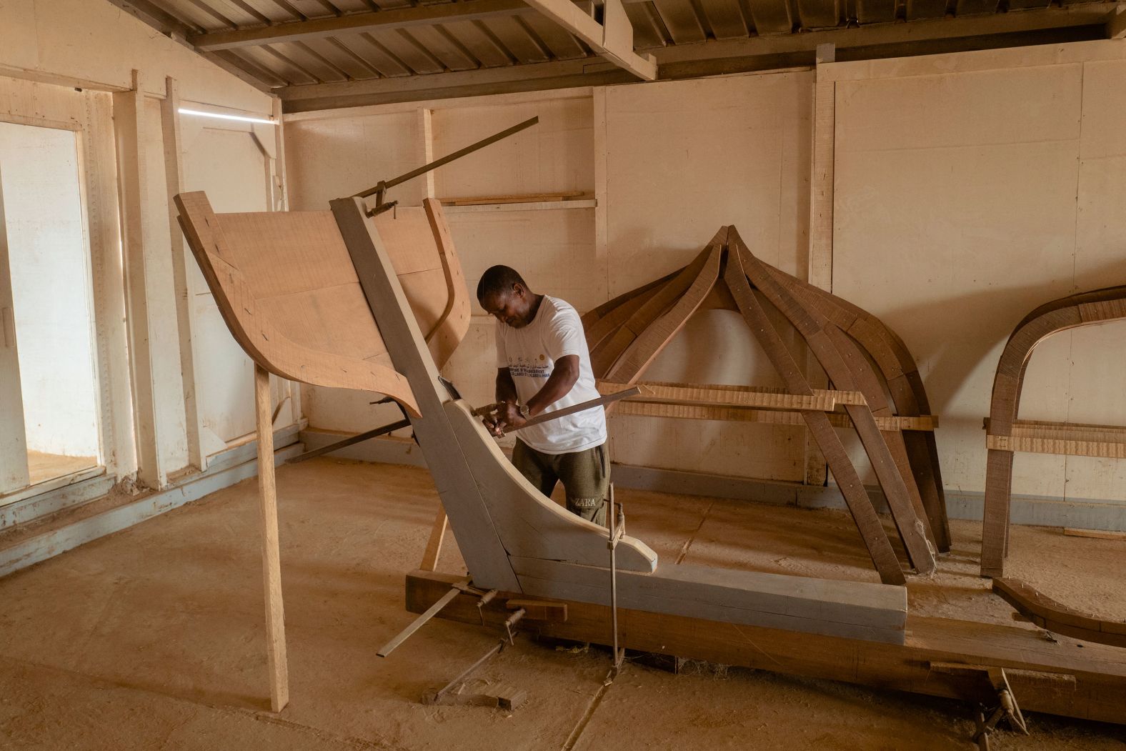 A shipbuilder works on a sailing boat in Mauritania’s Banc d'Arguin National Park on Friday, July 19.