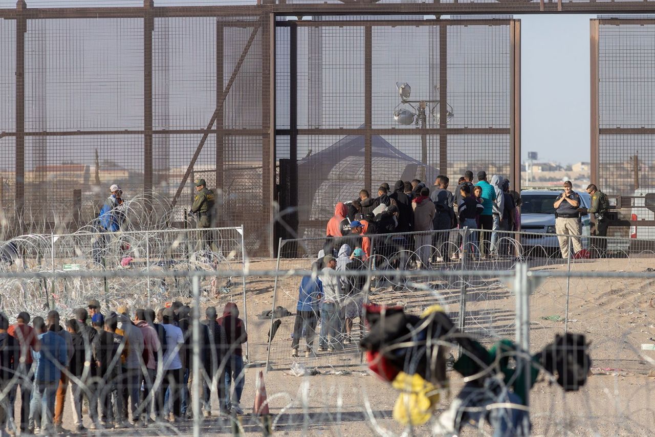 Migrants wait to be processed by the Border Patrol in Ciudad Juárez, Mexico, on March 15.