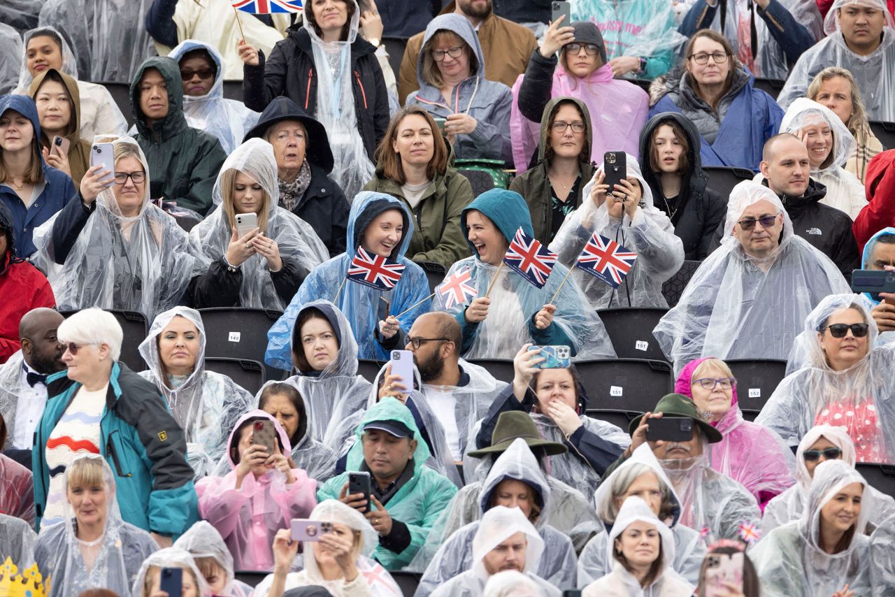 People brave the rain on the day of Britain's King Charles and Queen Camilla's coronation ceremony at Westminster Abbey. 