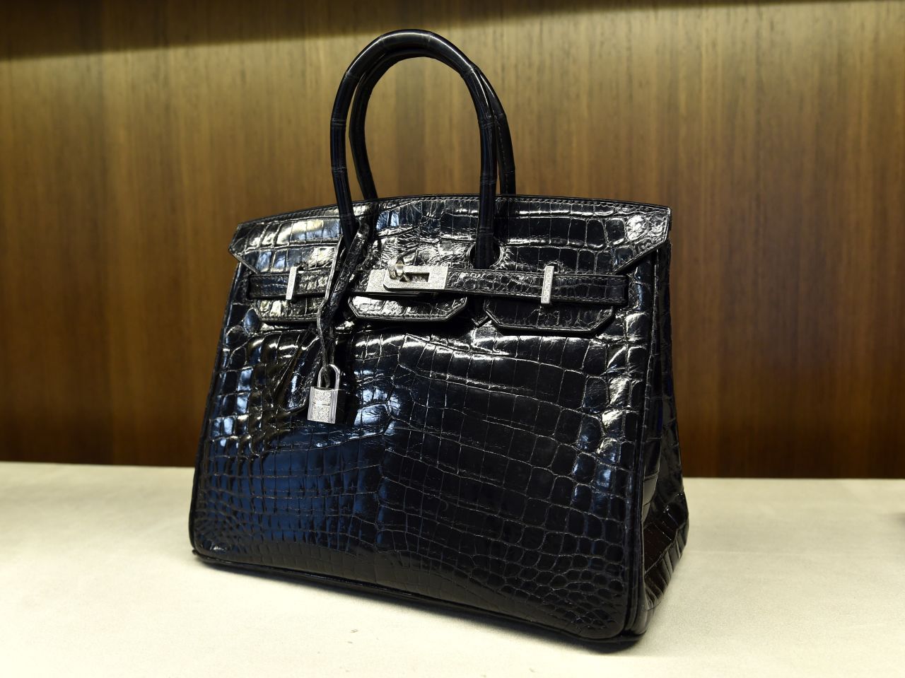 A shiny black crocodile Birkin bag is displayed in New York in 2014. Michael Cohen's plea said he failed to report proceeds of a similar bag.