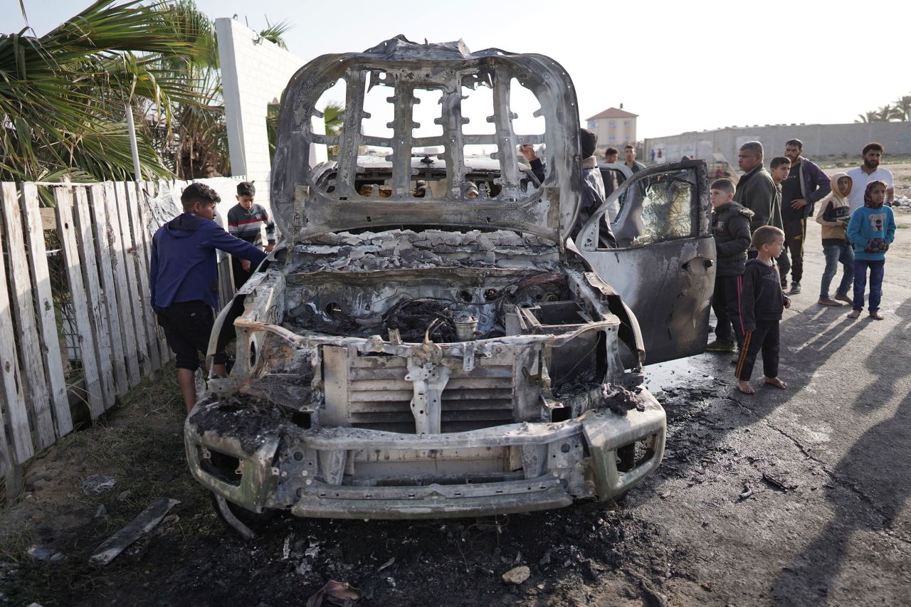 People gather around the World Central Kitchen vehicle that was hit by an Israeli strike the previous day in Deir al-Balah, Gaza, on April 2. 