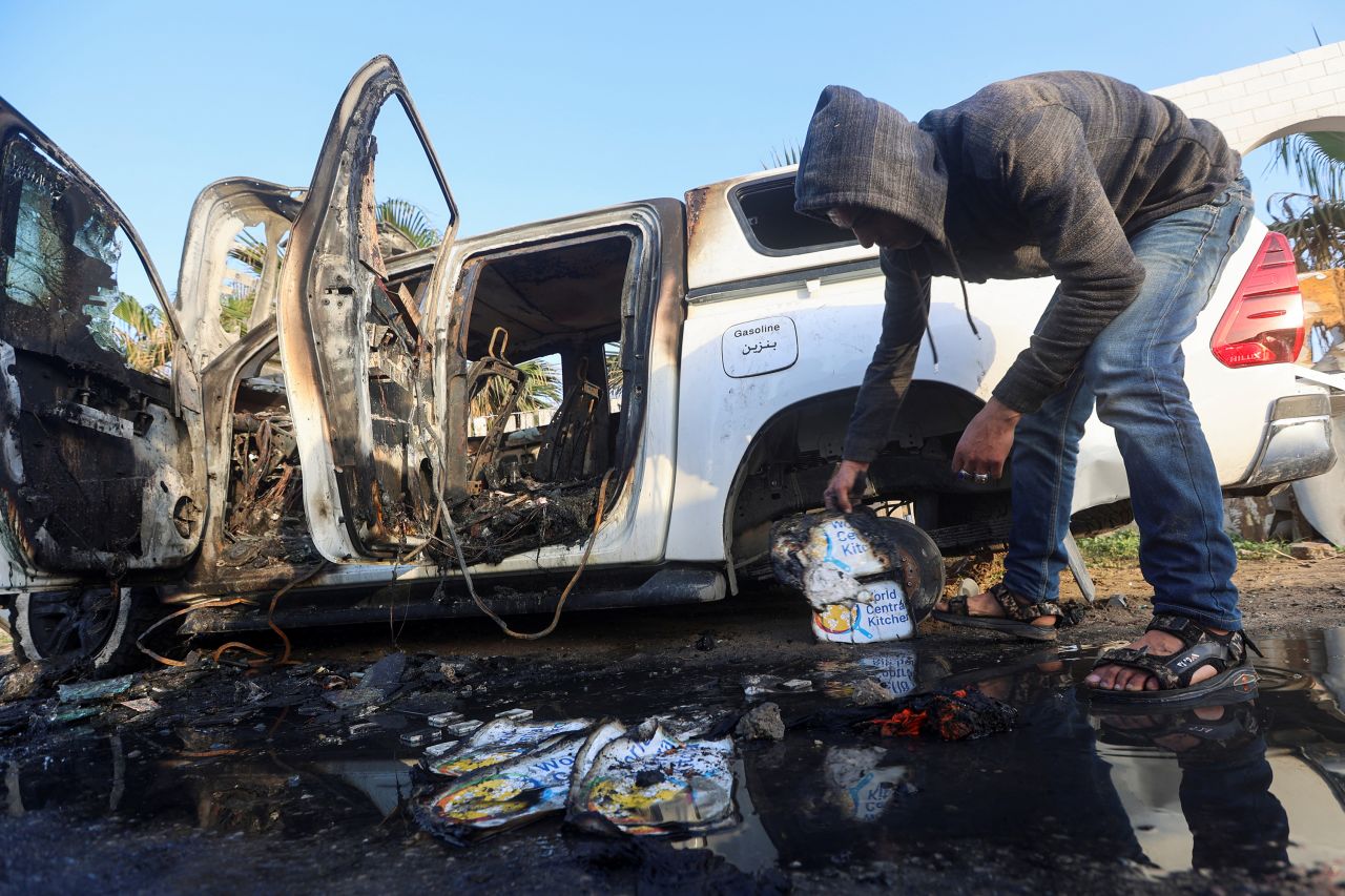 A Palestinian inspects near a vehicle where employees from the World Central Kitchen (WCK) were killed in an Israeli airstrike in Gaza, on April 2.