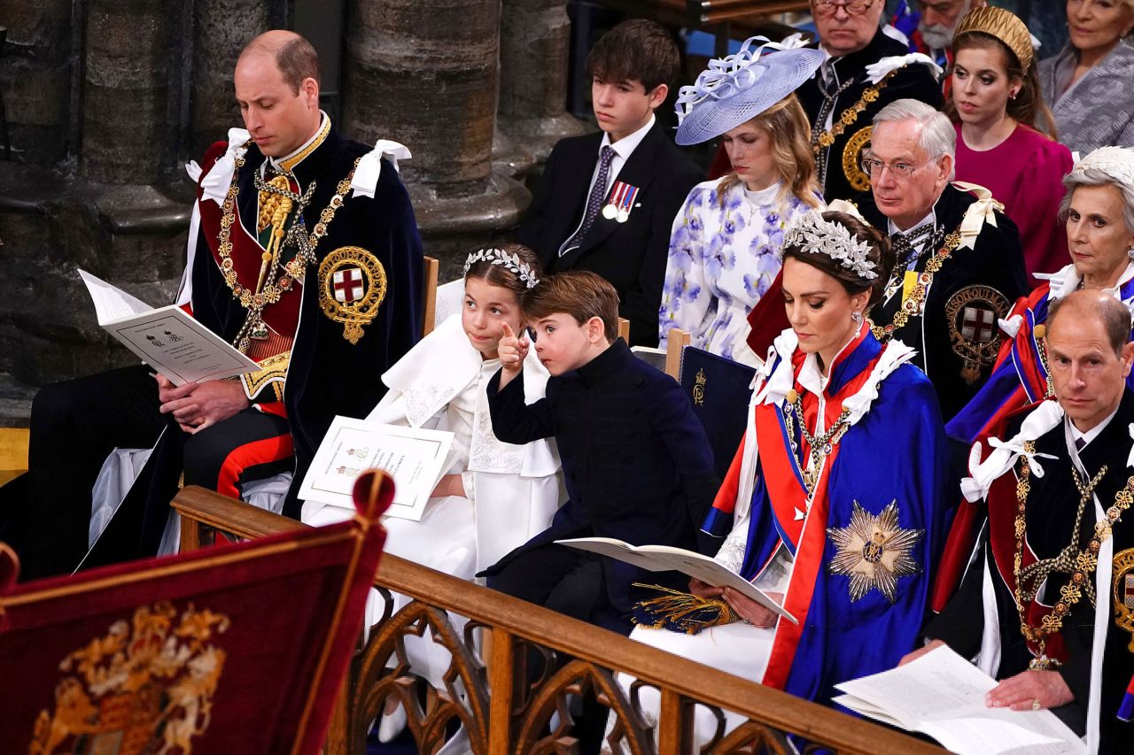 Princess Charlotte and Prince Louis point at something during the ceremony.