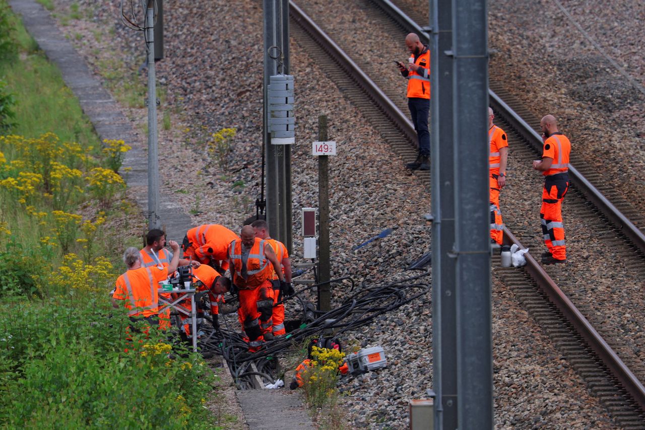 SNCF railway staff and police officers work at the site where vandals targeted France's high-speed train network in Croisilles, France, on July 26. 