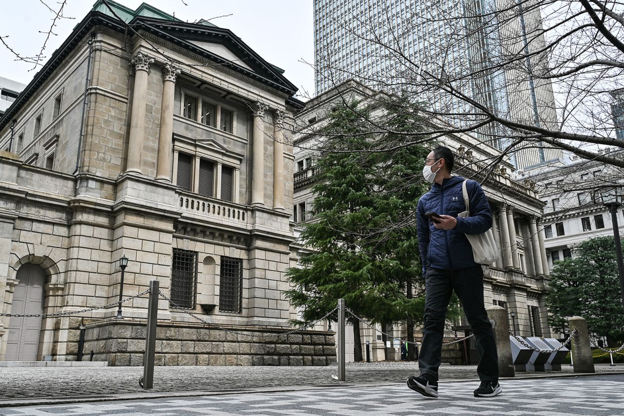 A man walks past the Bank of Japan (BoJ) headquarters complex in central Tokyo on March 19.