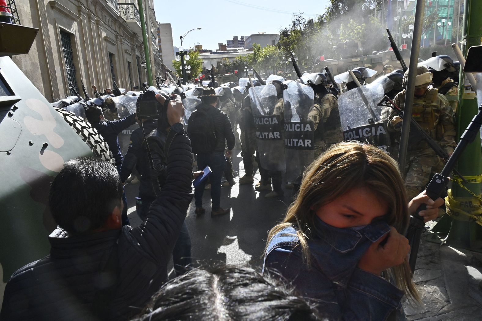 A woman walks away from tear gas fired by military troops in La Paz, Bolivia, on Wednesday, June 25. <a href="https://www.cnn.com/2024/06/26/americas/bolivia-coup-attempt-claims-intl-latam/index.html">A Bolivian general was arrested and accused of mounting a coup against the government</a> after attempting to storm the presidential palace on Wednesday.