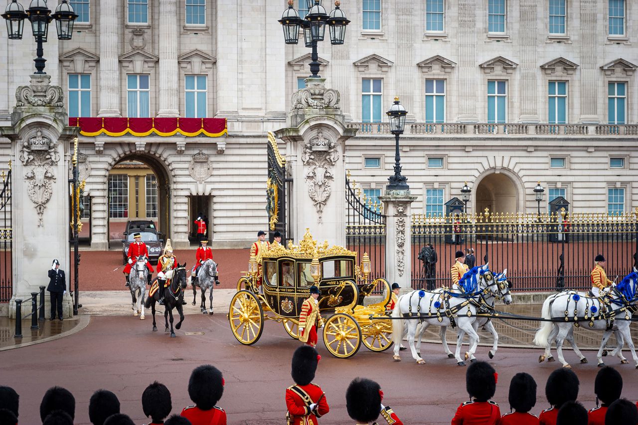 The King and Queen leave Buckingham Palace on their way to the coronation.