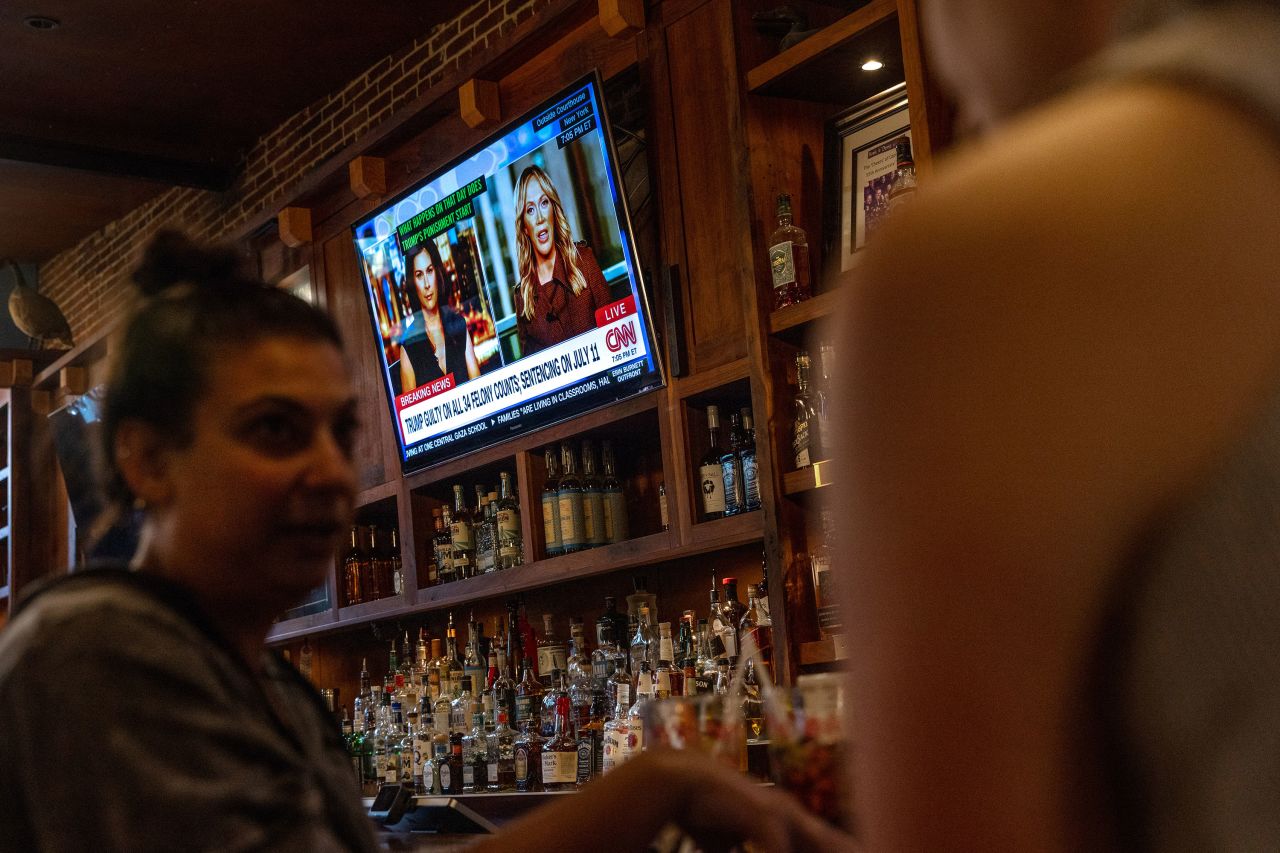 People eat and drink while CNN’s coverage of the trial plays in the background at Hawk ’n' Dove in Washington, DC, on May 30.