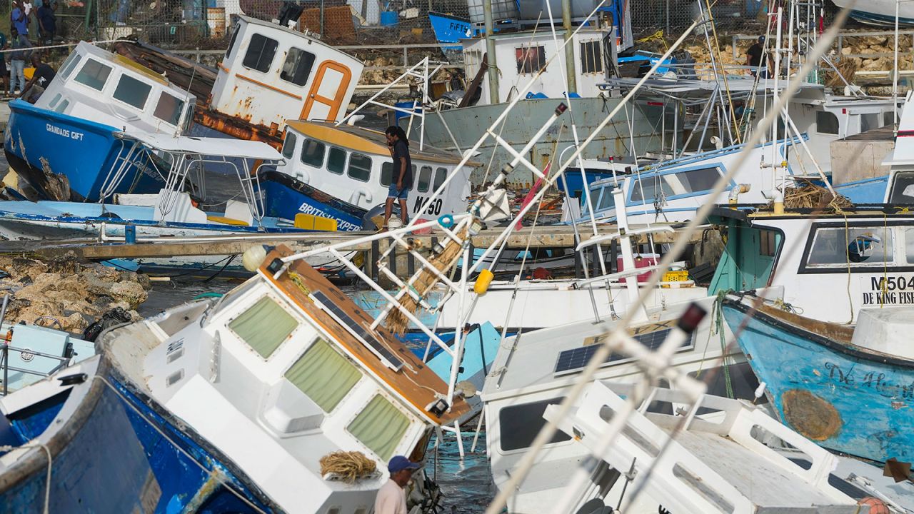 A fisherman looks at fishing vessels damaged by Hurricane Beryl at the Bridgetown Fisheries in Barbados, on Monday, July 1.