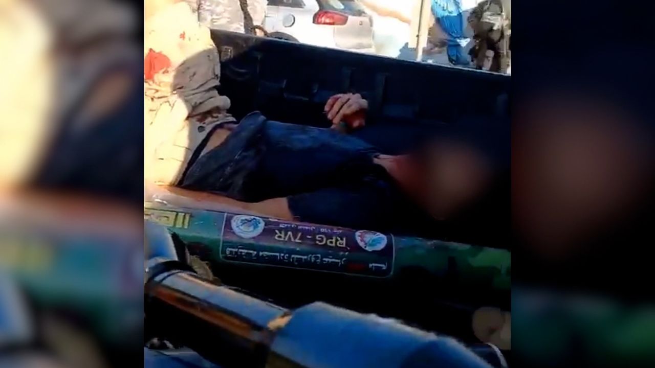 In this screen grab from video, a victim lies in the back of a truck during a kidnapping of three Israelis on October 7. The video was blurred by the source.