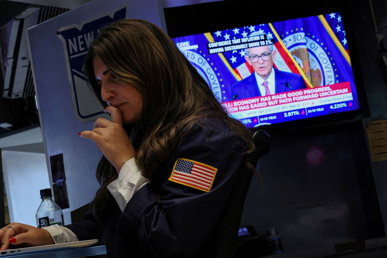 A trader works, as a screen displays a news conference by Federal Reserve Board Chairman Jerome Powell following the Fed rate announcement, on the floor of the New York Stock Exchange on January 31.