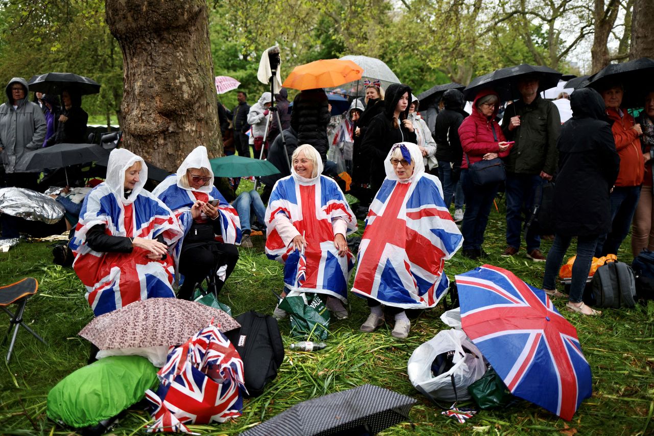 People on The Mall listen to the service in the rain on loudspeakers.