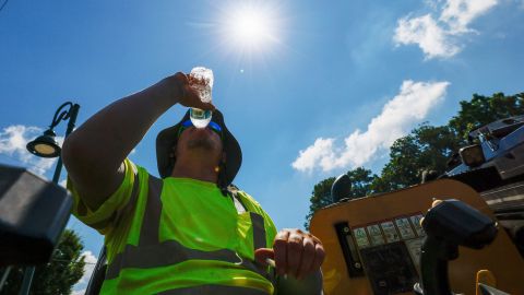 Construction worker Daren True drinks water as temperatures soar in Metro Atlanta on Monday, June 24, 2024. The heat indexes were likely to soar past 100 degrees in the next few days. (Miguel Martinez/Atlanta Journal-Constitution via AP)