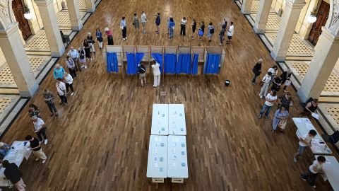 Voters wait at a polling station to vote in the first round of the French parliamentary election, in Lyon, central France, Sunday, June 30, 2024. Voters across mainland France are casting ballots in the first round of an exceptional parliamentary election.