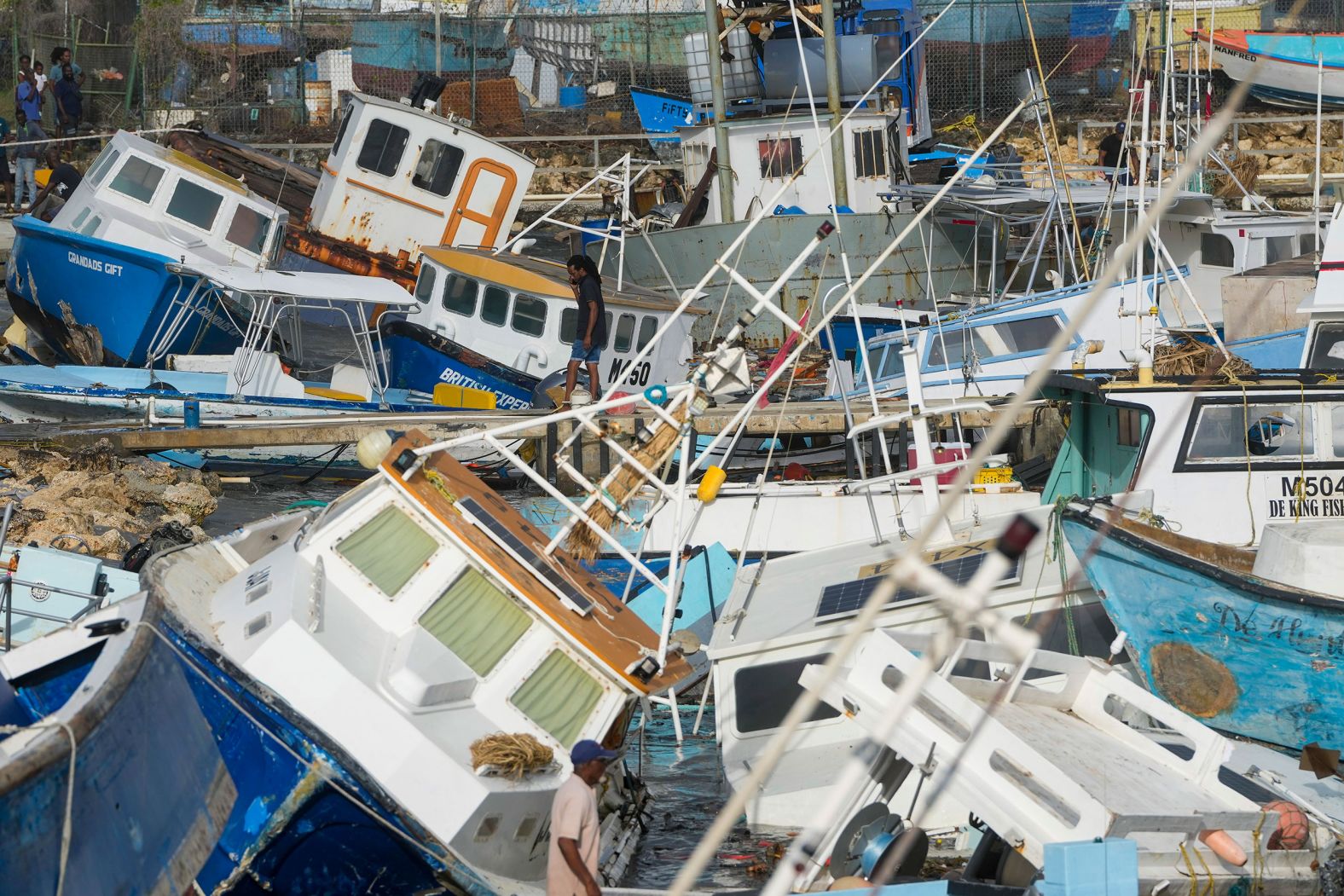 Fishing boats, damaged by Hurricane Beryl, sit in a heap Monday at the Bridgetown Fisheries in Barbados.