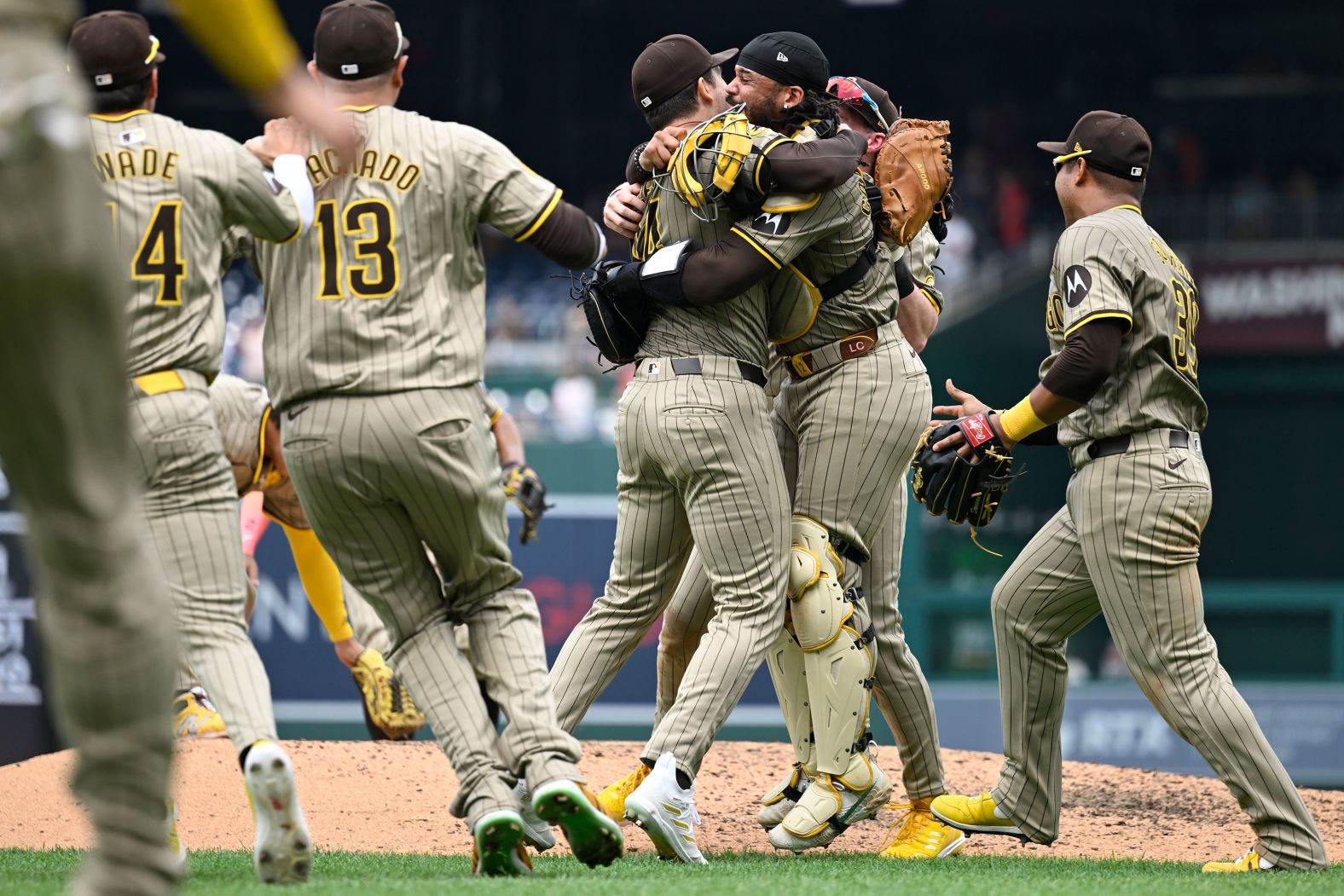 Players from the San Diego Padres rush the field to celebrate a no-hitter thrown by pitcher Dylan Cease, center, in Washington, DC, on Thursday, July 25. It was the second no-hitter in team history.