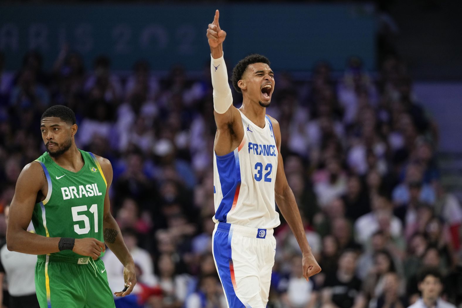 French basketball superstar Victor Wembanyama celebrates a Brazil turnover during the teams' opening game on July 27. Wembanyama had 19 points, nine rebounds, two assists, four steals and three blocks as <a href="https://www.cnn.com/sport/live-news/paris-olympics-news-2024-07-27#h_adc7279c0a5db023f742855ffd868995">France won 78-66</a>.