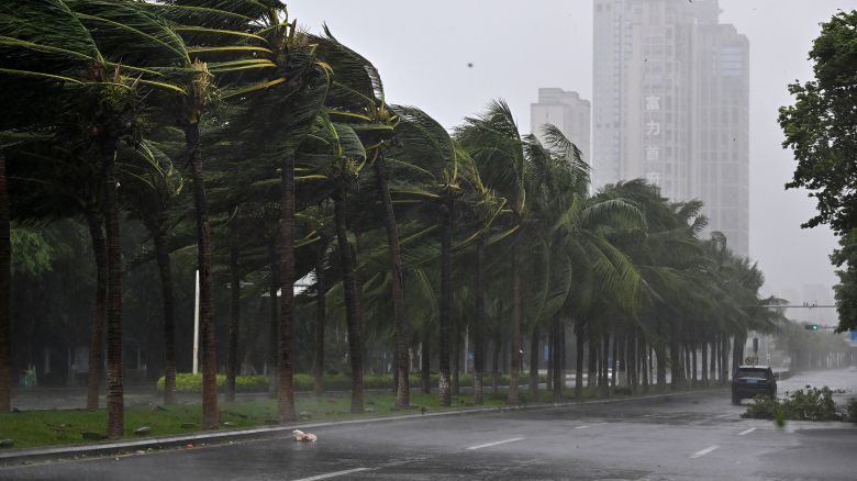 In this photo released by Xinhua News Agency, a vehicle moves past trees along a road in Haikou following the landfall of typhoon Yagi, in south China's Hainan Province, Friday, Sept. 6, 2024. (Guo Cheng/Xinhua via AP)