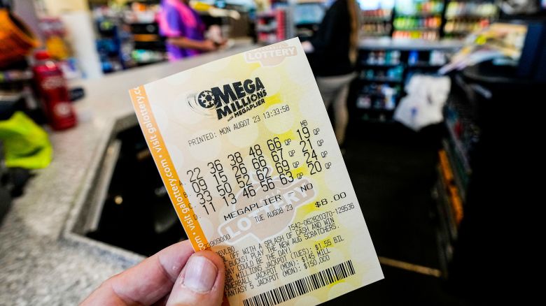 FILE - A Mega Millions ticket is seen as a person makes a purchase inside a convenience store, Aug. 7, 2023, in Kennesaw, Ga.  (AP Photo/Mike Stewart, File)