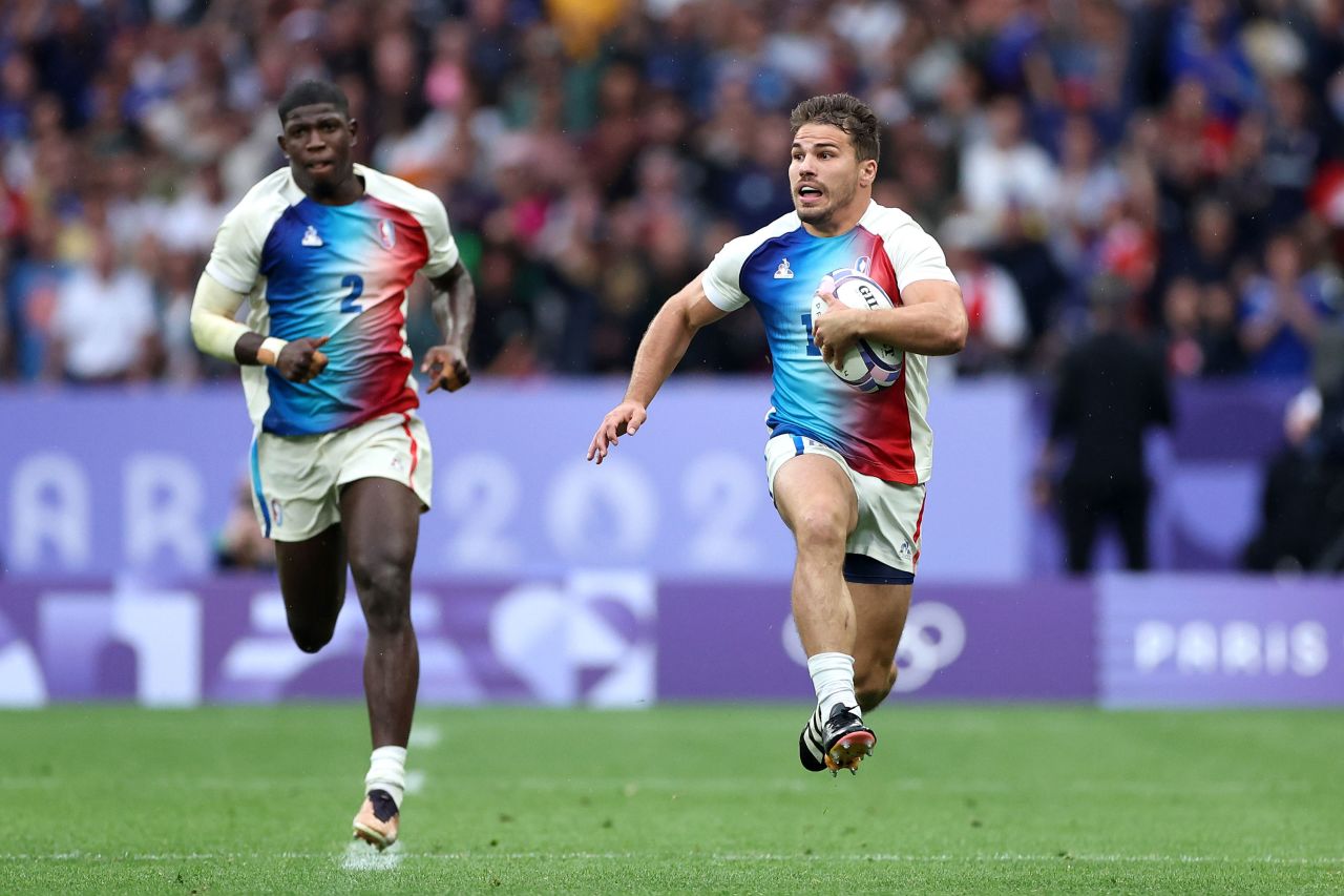 France's Antoine Dupont, right, breaks with the ball during a men's rugby sevens match against Fiji at Stade de France in Saint-Denis, France, on July 27. 