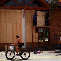 People board-up a window before the arrival of Hurricane Beryl, in Playa del Carmen, Mexico, July 4, 2024. 