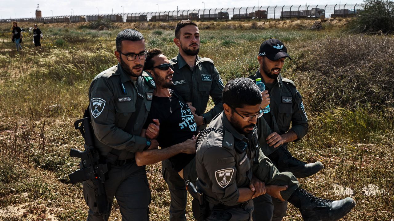 Israeli security forces apprehend a protester from the Tsav 9 movement as the group performs a sit-in in an attempt to block aid shipments from getting into Gaza, in Kerem Shalom, Israel, on March 7. 