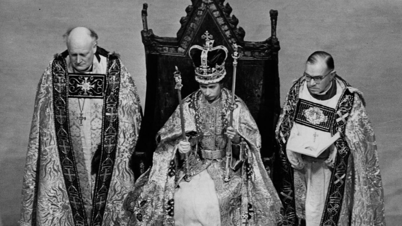 The Queen holds her symbols of office after the ceremony.