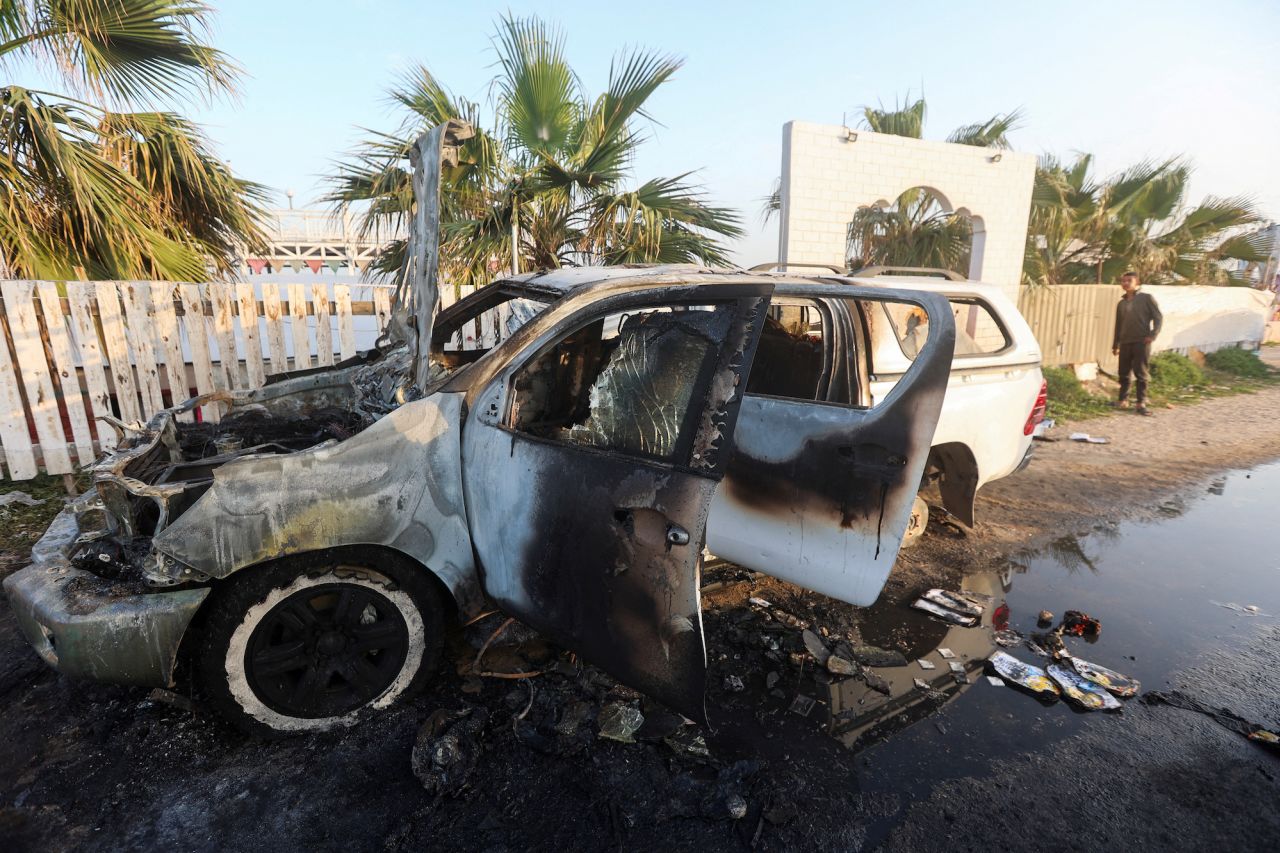 A person looks at a vehicle where employees from the World Central Kitchen were killed in an Israeli airstrike in Deir Al-Balah, central Gaza, on April 2.