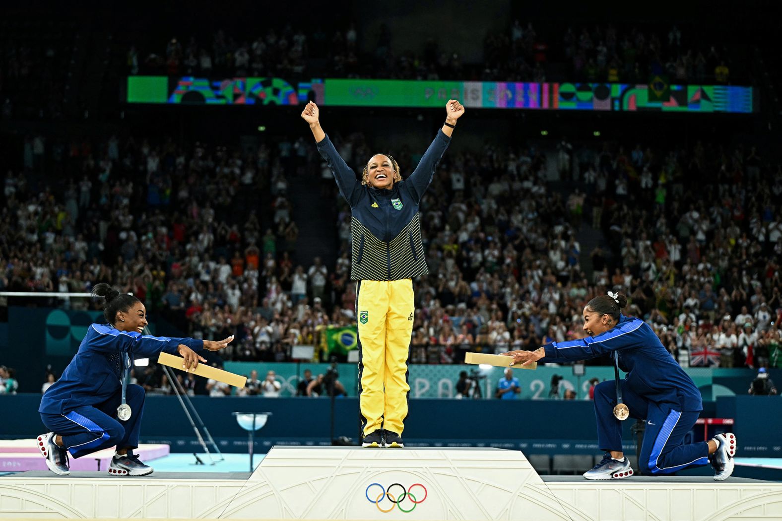 American gymnasts Simone Biles, left, and Jordan Chiles <a href="https://www.cnn.com/sport/live-news/paris-olympics-news-2024-08-05#h_50b58405671680084384da391d48ef6f">bow to Brazil's Rebeca Andrade</a> after she won Olympic gold in the floor exercise on August 5. It was <a href="https://www.cnn.com/2024/08/06/sport/us-gymnasts-sportsmanship-wins-hearts-podium-int-hnk/index.html">the first all-Black Olympics gymnastics podium</a>. However, on August 11, the International Olympic Committee announced that <a href="https://www.cnn.com/sport/live-news/paris-olympics-news-closing-ceremony#h_55351da504525ebe71af920a8ed27e95">Chiles' bronze medal would be reallocated to Romanian gymnast Ana Bărbosu</a> after the Court of Arbitration for Sport ruled that an appeal made by the United States over Chiles' score was filed too late.