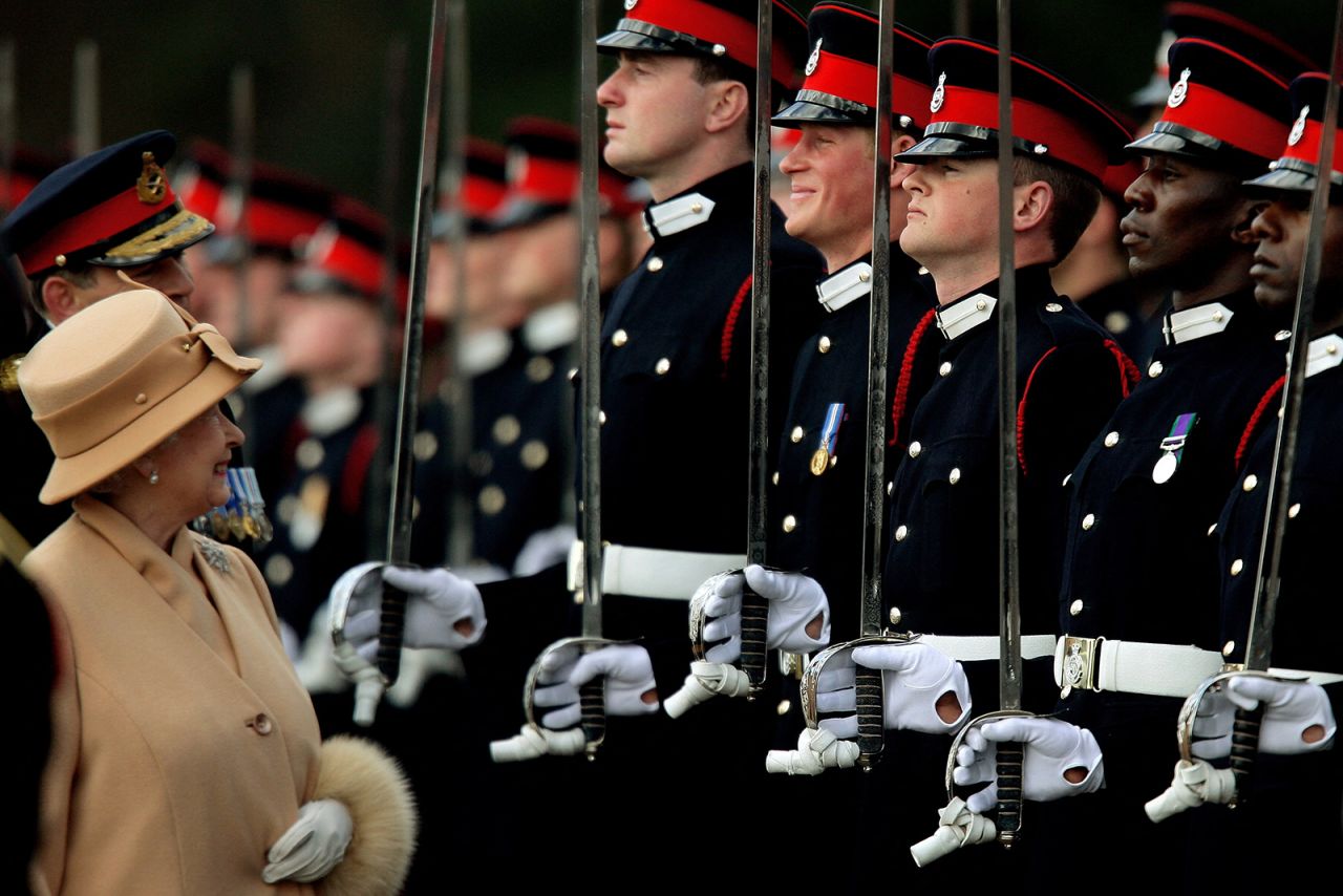 Queen Elizabeth smiles with Prince Harry during the Sovereign's Parade at the Royal Military Academy in Sandhurst, on April 12, 2006. 