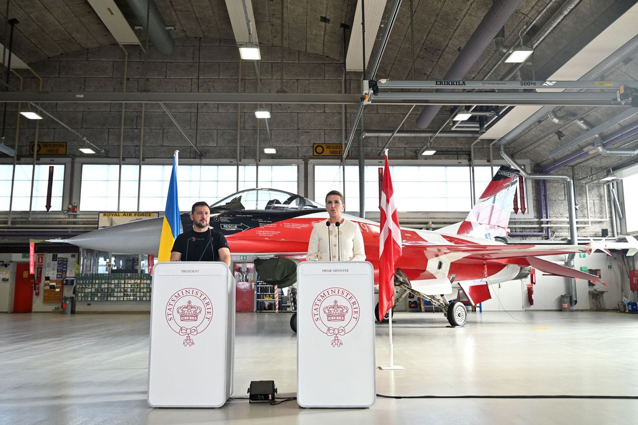 Ukrainian President Volodymyr Zelensky, left, and Danish Prime Minister Mette Frederiksen address a press confrence in front of a F-16 fighter jet in the hangar of the Skrydstrup Airbase in Vojens, northern Denmark, on August 20.