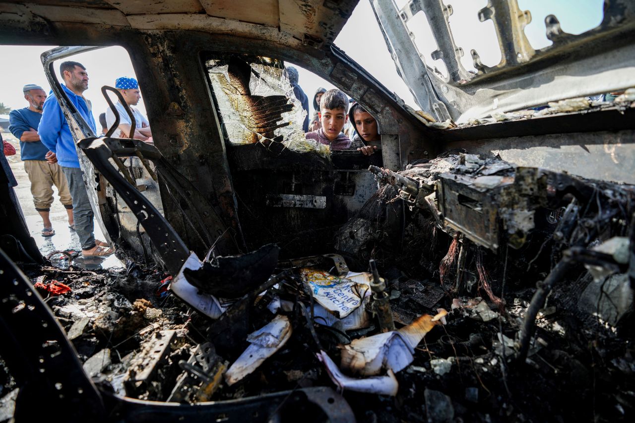 People inspect the site where World Central Kitchen workers were killed in Deir al-Balah, Gaza, on April 2. 