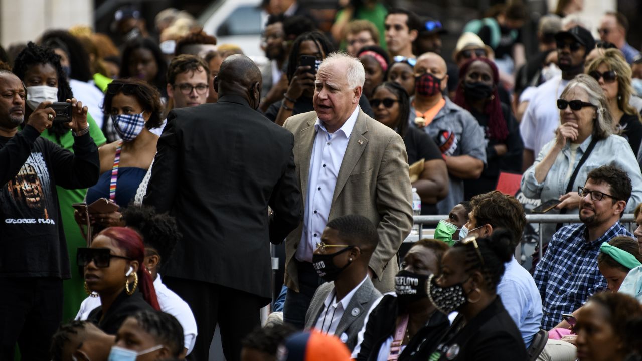 MINNEAPOLIS, MN - MAY 23: Attorney Ben Crump greets Minnesota Governor Tim Walz (C) as people attend a rally outside the Hennepin County Government Center on May 23, 2021 in Minneapolis, Minnesota. The National Action Network and members of George Floyd's family hosted an inaugural remembrance to honor the life of Floyd, who was killed by former Minneapolis police officer Derek Chauvin on May 25, 2020. Chauvin has since been convicted of multiple murder counts in Floyds death. (Photo by Stephen Maturen/Getty Images)