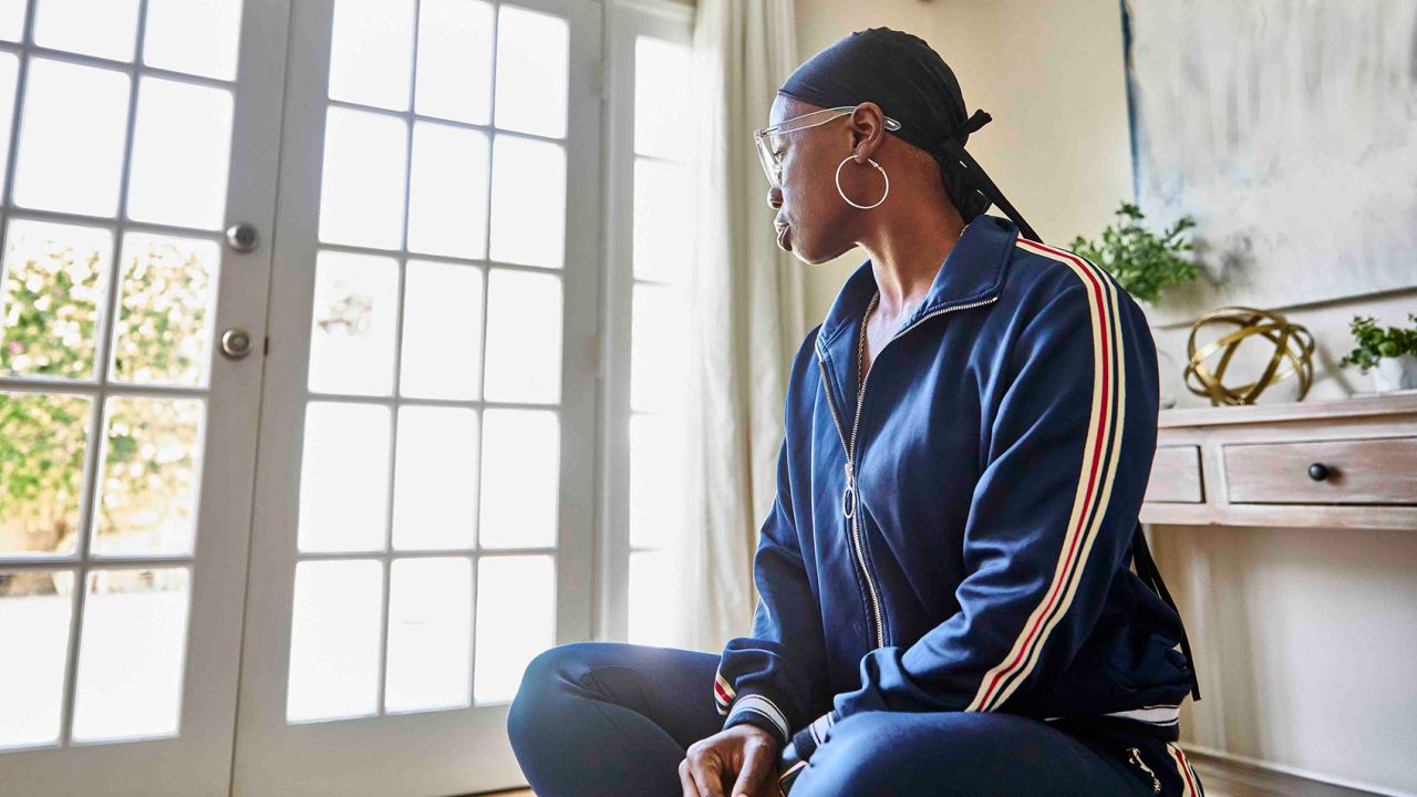 Female cancer patient looking away while sitting at home