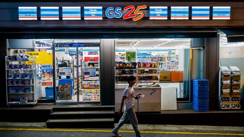 A man walks past a GS25 convenience store along a street in Seoul on August 18, 2023. (Photo by Anthony WALLACE / AFP) (Photo by ANTHONY WALLACE/AFP via Getty Images)