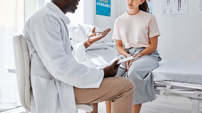 Doctor consulting patient for covid vaccine, wellness check and medical test results in clinic surgery. Healthcare worker and hospital staff in discussion about medicine service and healthy feedback