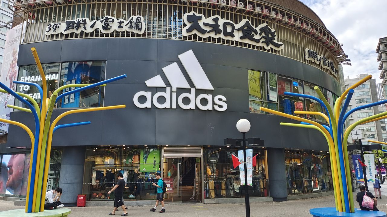 SHANGHAI, CHINA - SEPTEMBER 29, 2022 - (FILE) People walk past the flagship store of sportswear brand adidas in Shanghai, China, September 29, 2022. (Photo credit should read CFOTO/Future Publishing via Getty Images)